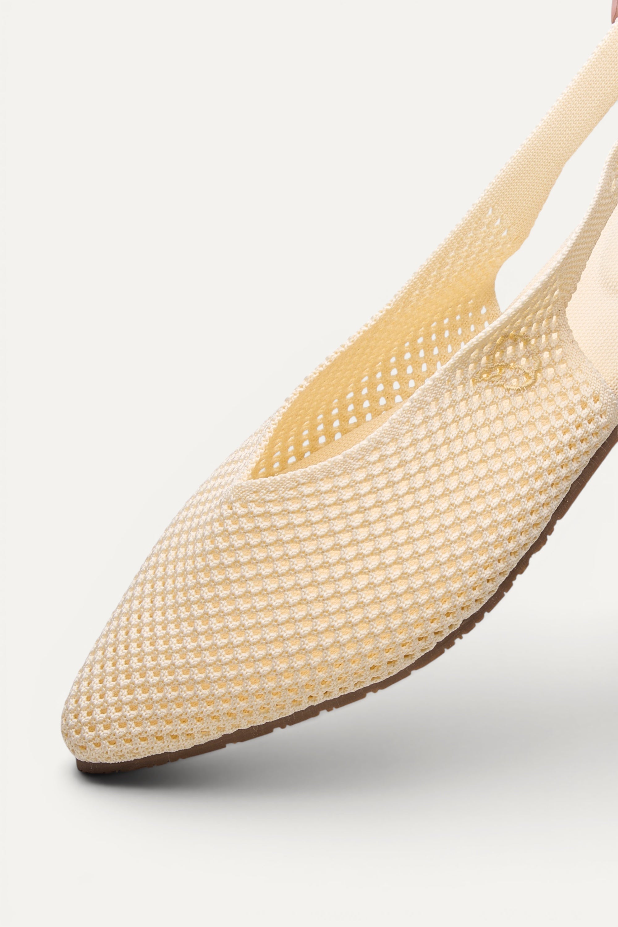 Side view of Rioz Ivory Airknit Slingbacks, sleek pointed-toe knit flats with open-mesh upper.