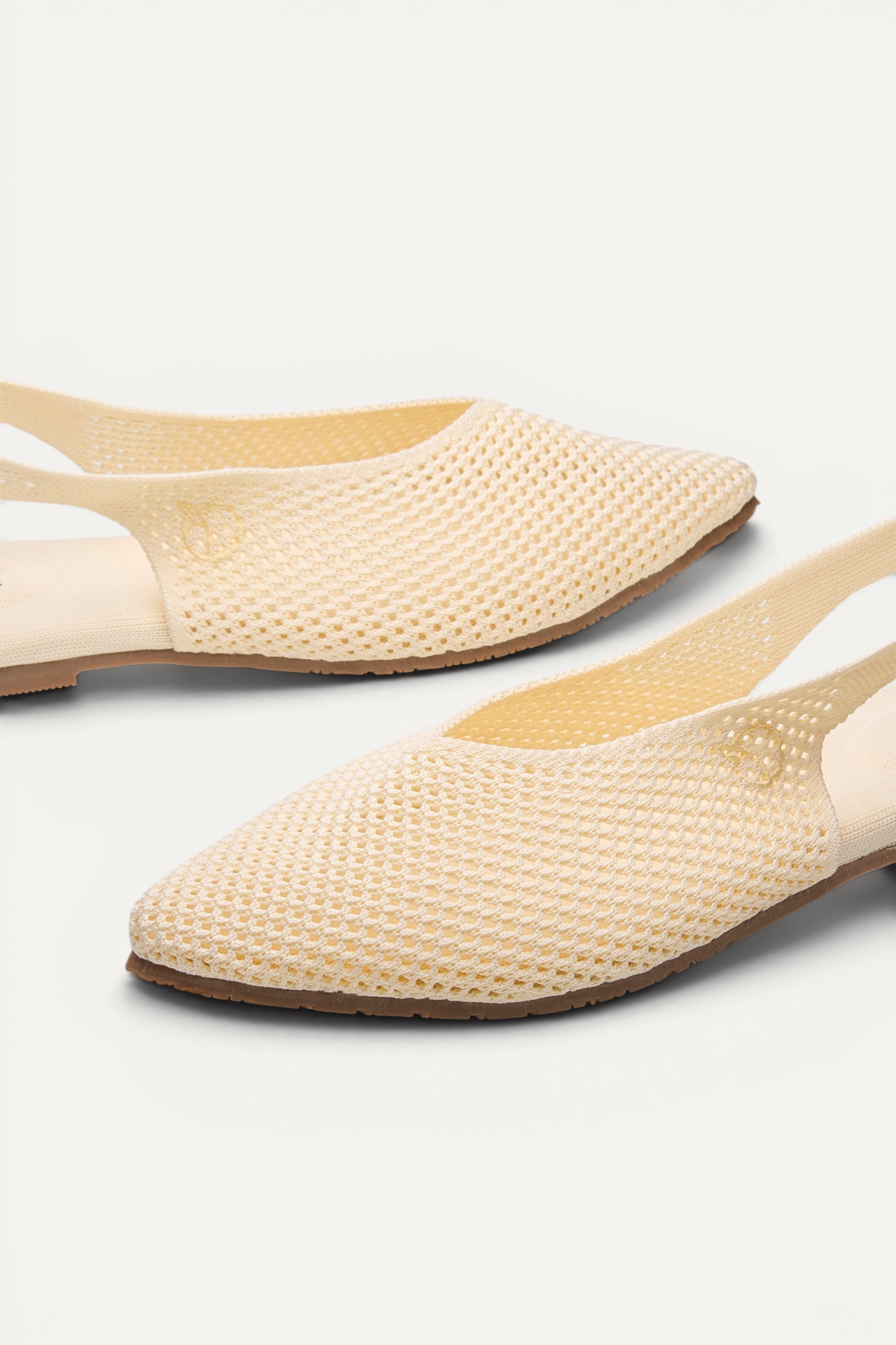 Top view of Rioz Airknit Slingbacks (ivory, pointed-toe), lightweight knit flats from rPET bottles.