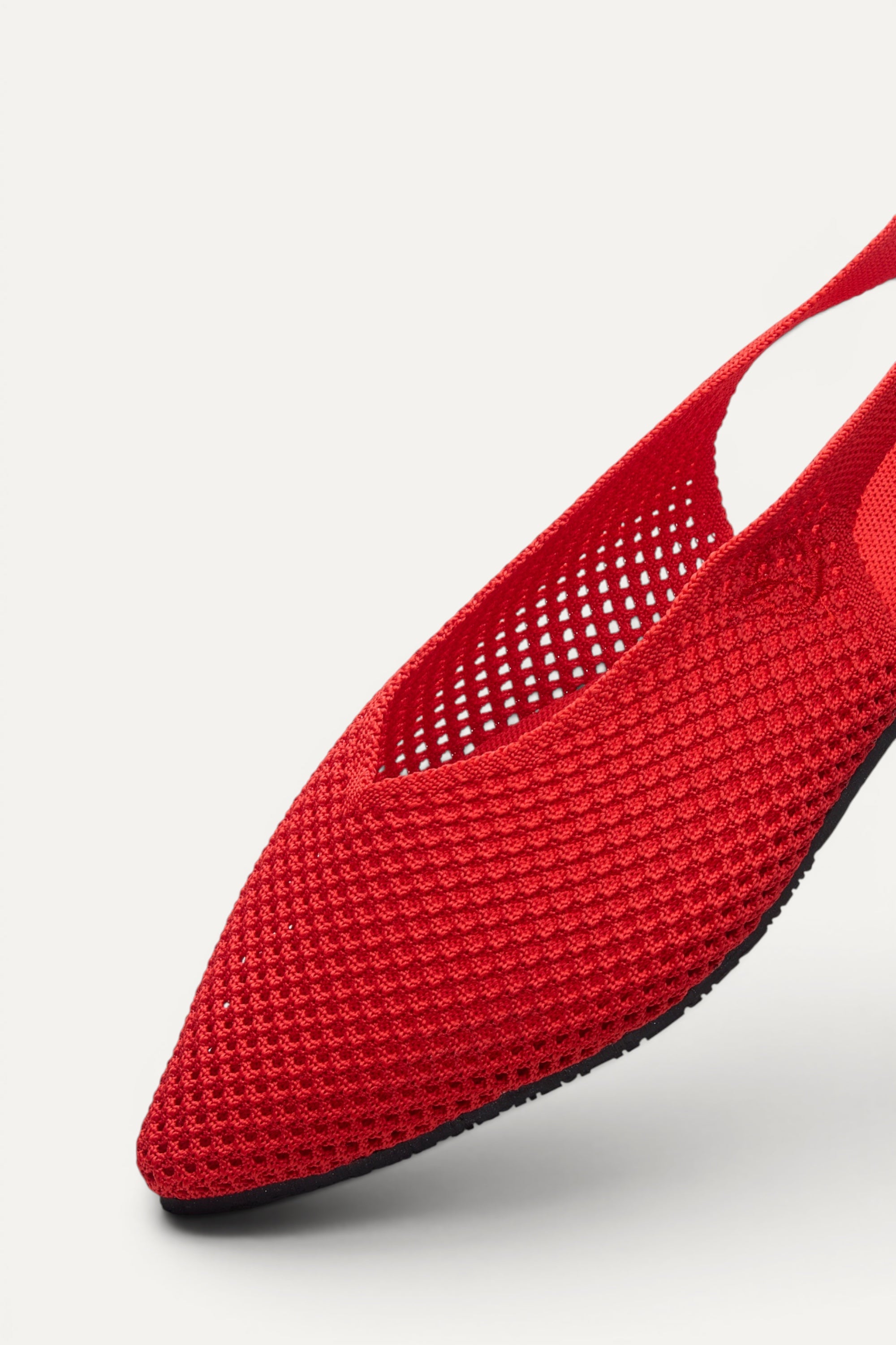 Side view of Rioz Red Airknit Slingbacks, sleek pointed-toe knit flats with open-mesh upper.
