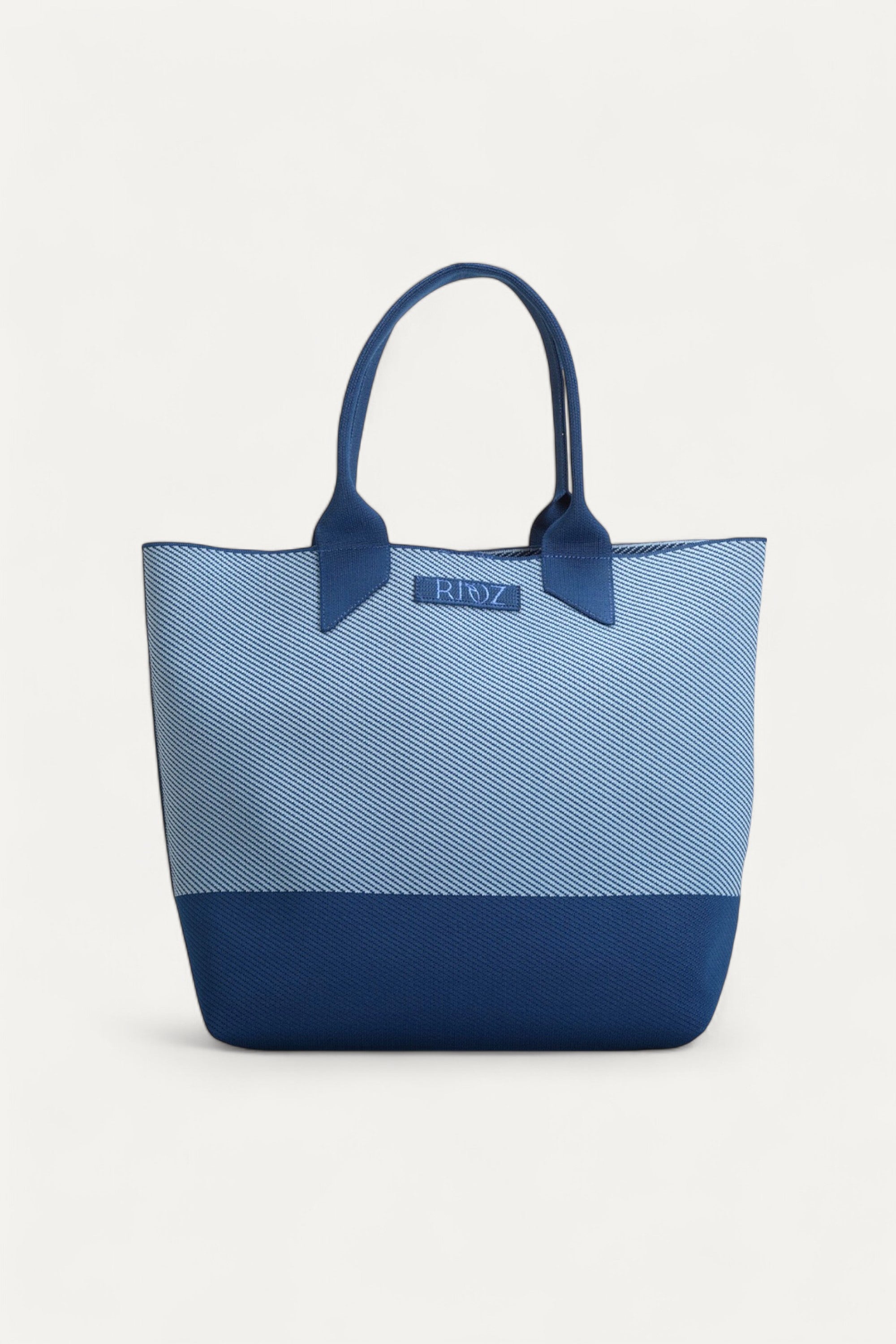 Rioz tote bag for women with dual handles, spacious design, and stylish fabric finish made from recycled PET bottles for sustainable everyday use.