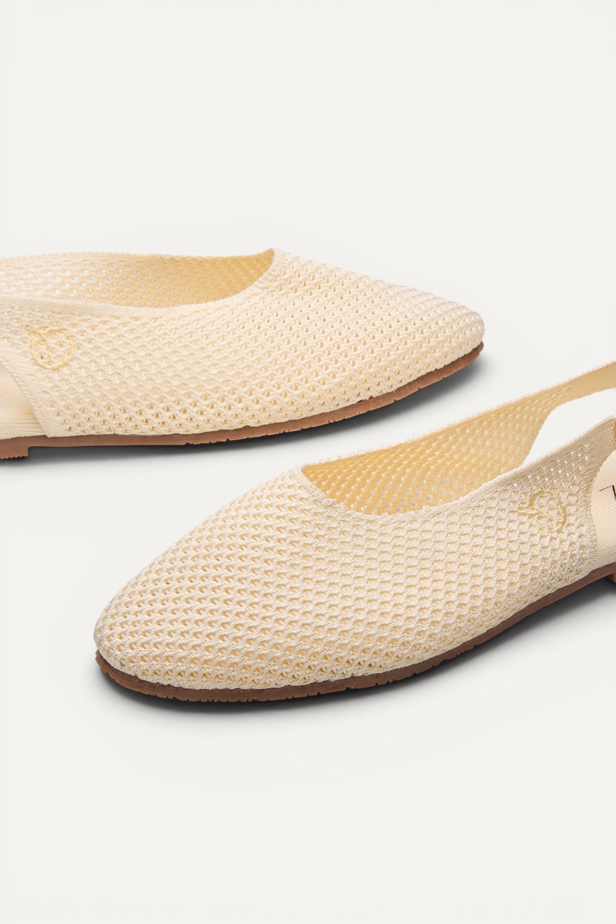 Top view of Rioz Airknit Slingbacks (ivory, almond-toe), lightweight knit flats made in India from rPET.