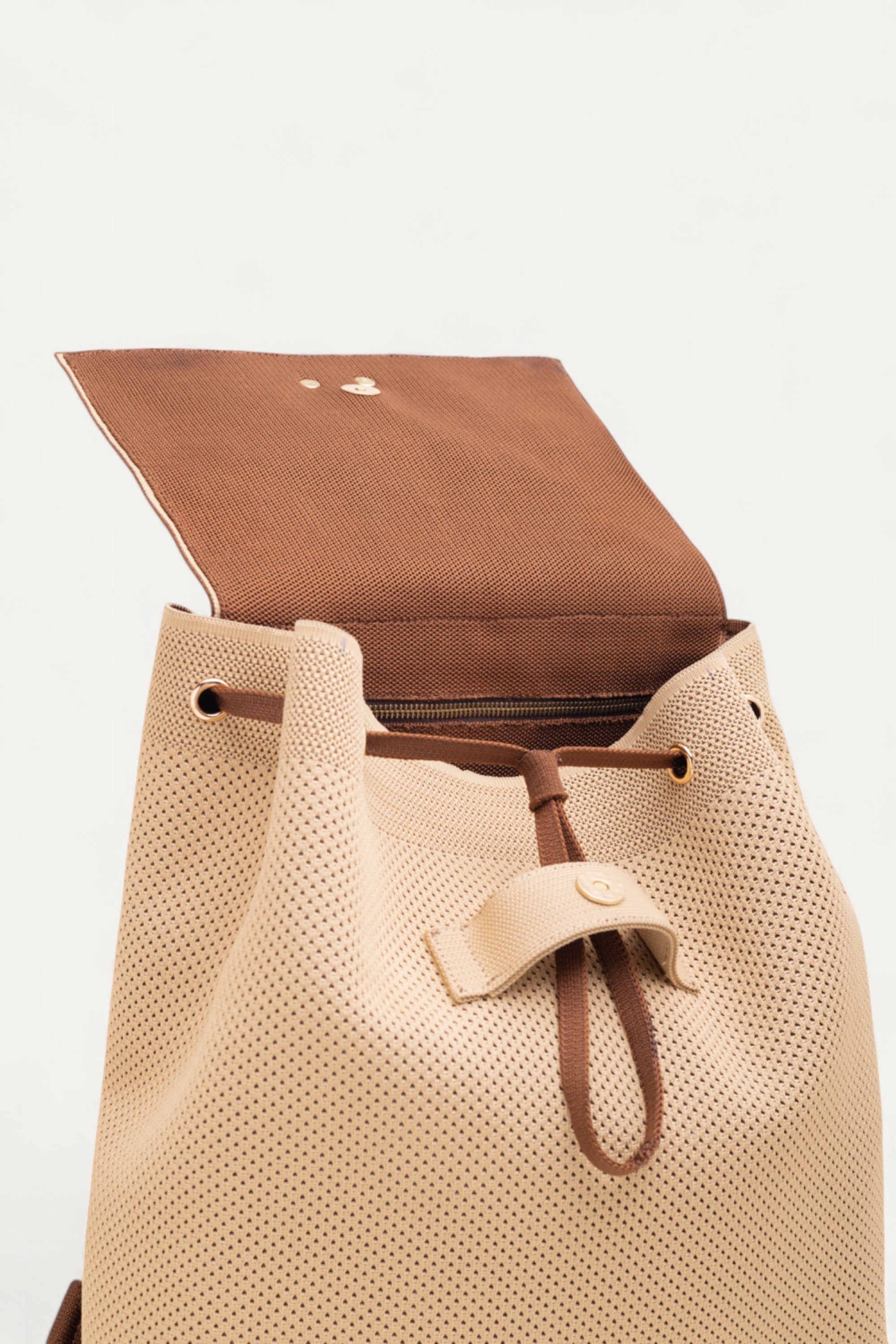 Top view of eco-friendly Rioz backpack with open flap and drawstring closure showing its spacious interior; made from recycled PET bottles and machine-washable.