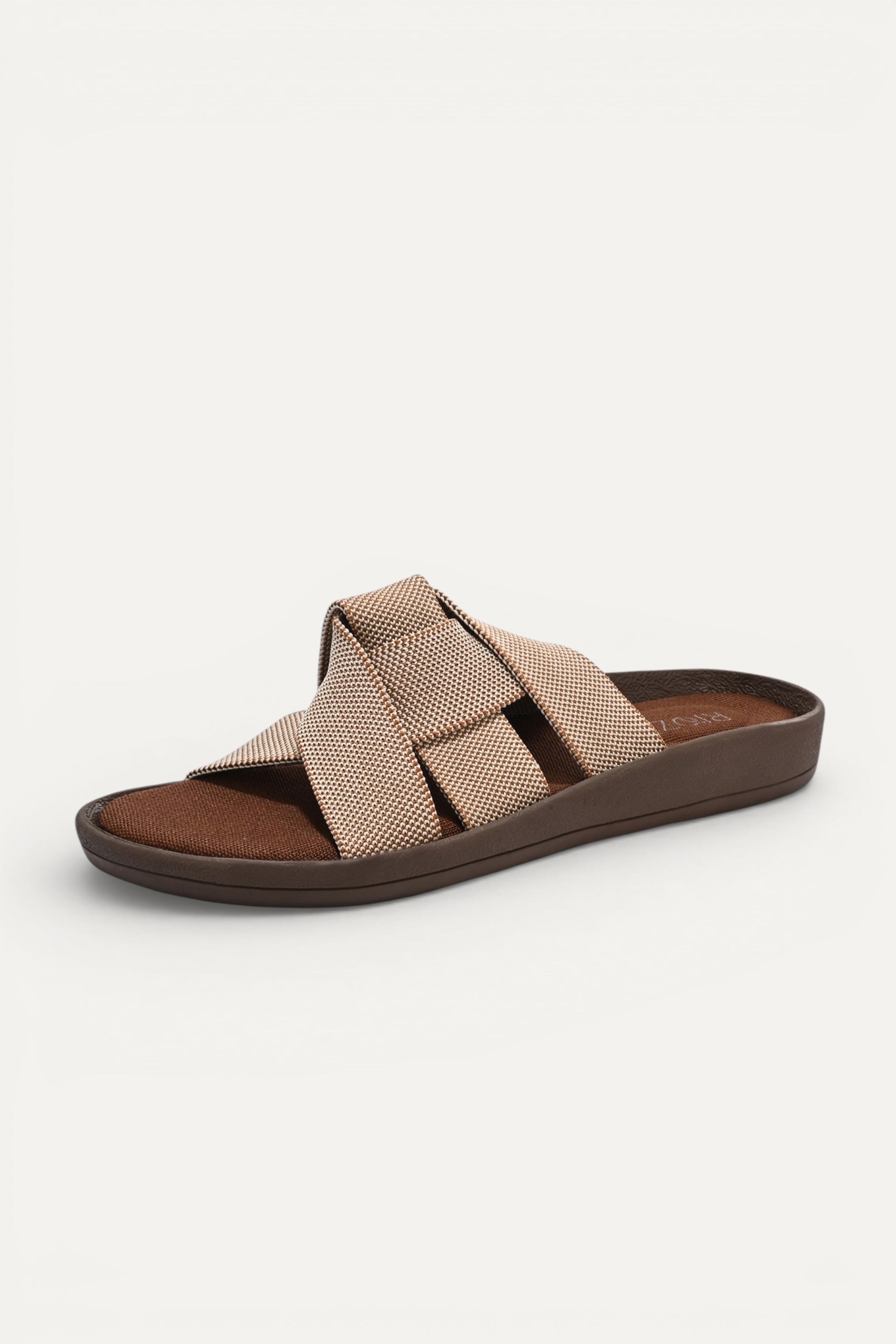 RIOZ eco-friendly slip-on sandals with brown beige woven bow straps, cushioned tan footbed, and brown sole, designed for lightweight everyday comfort and sustainable style.