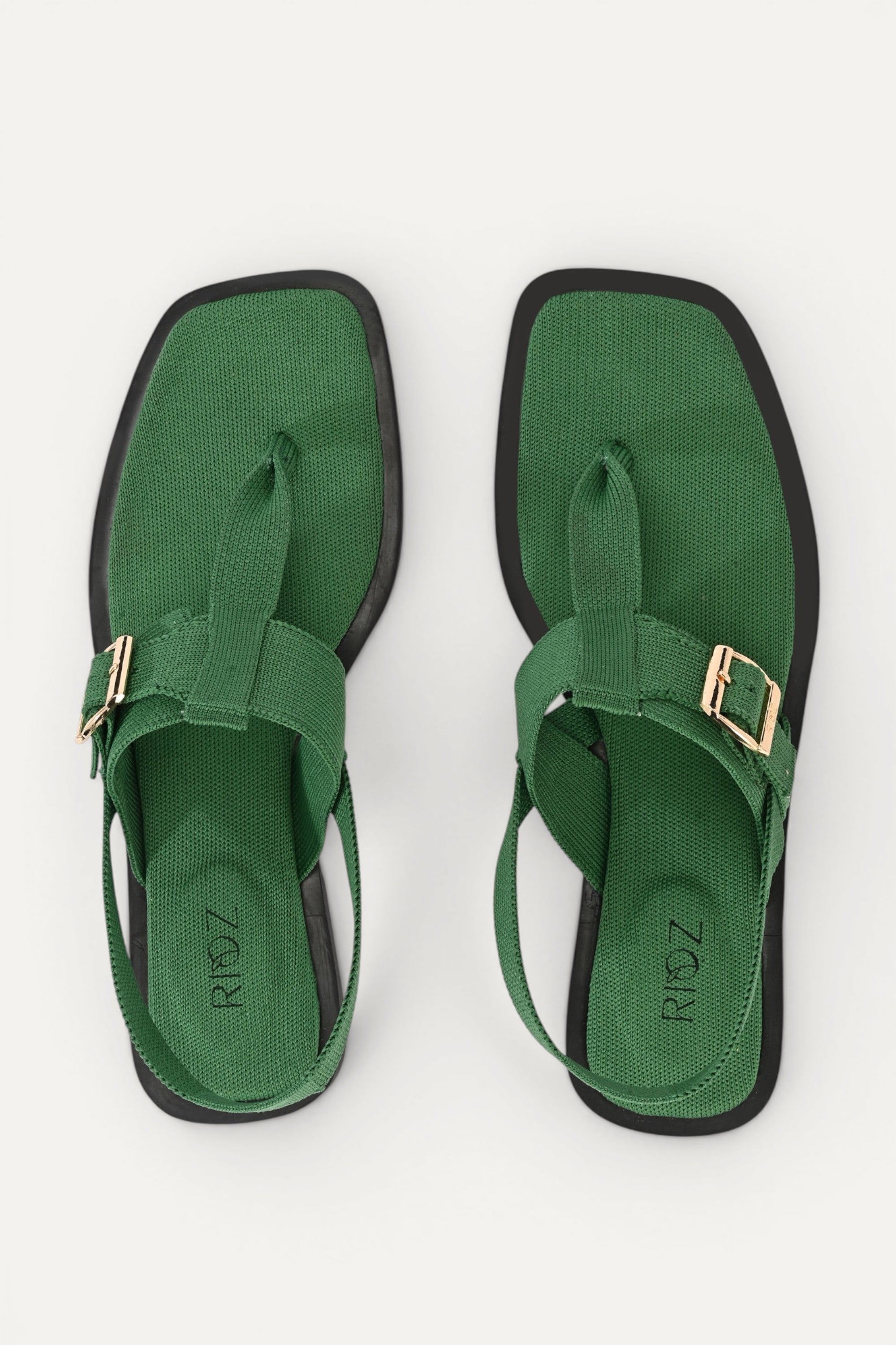 RIOZ eco-friendly green slingback sandals with adjustable buckle straps, breathable woven texture, cushioned footbed, and lightweight sole for comfortable everyday wear.