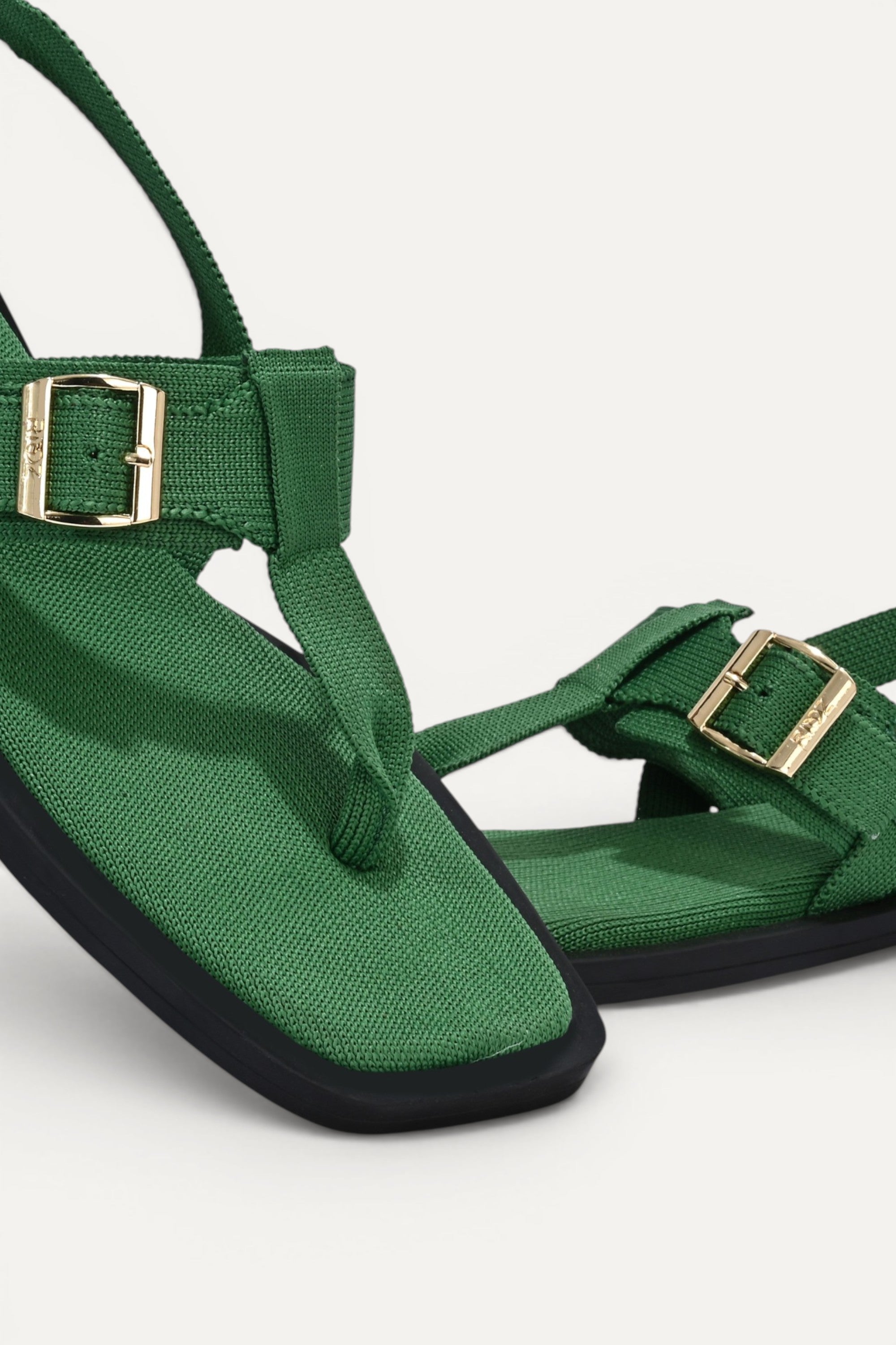 RIOZ eco-friendly green slingback sandals with adjustable buckle straps, breathable woven texture, cushioned footbed, and lightweight sole for comfortable everyday wear.