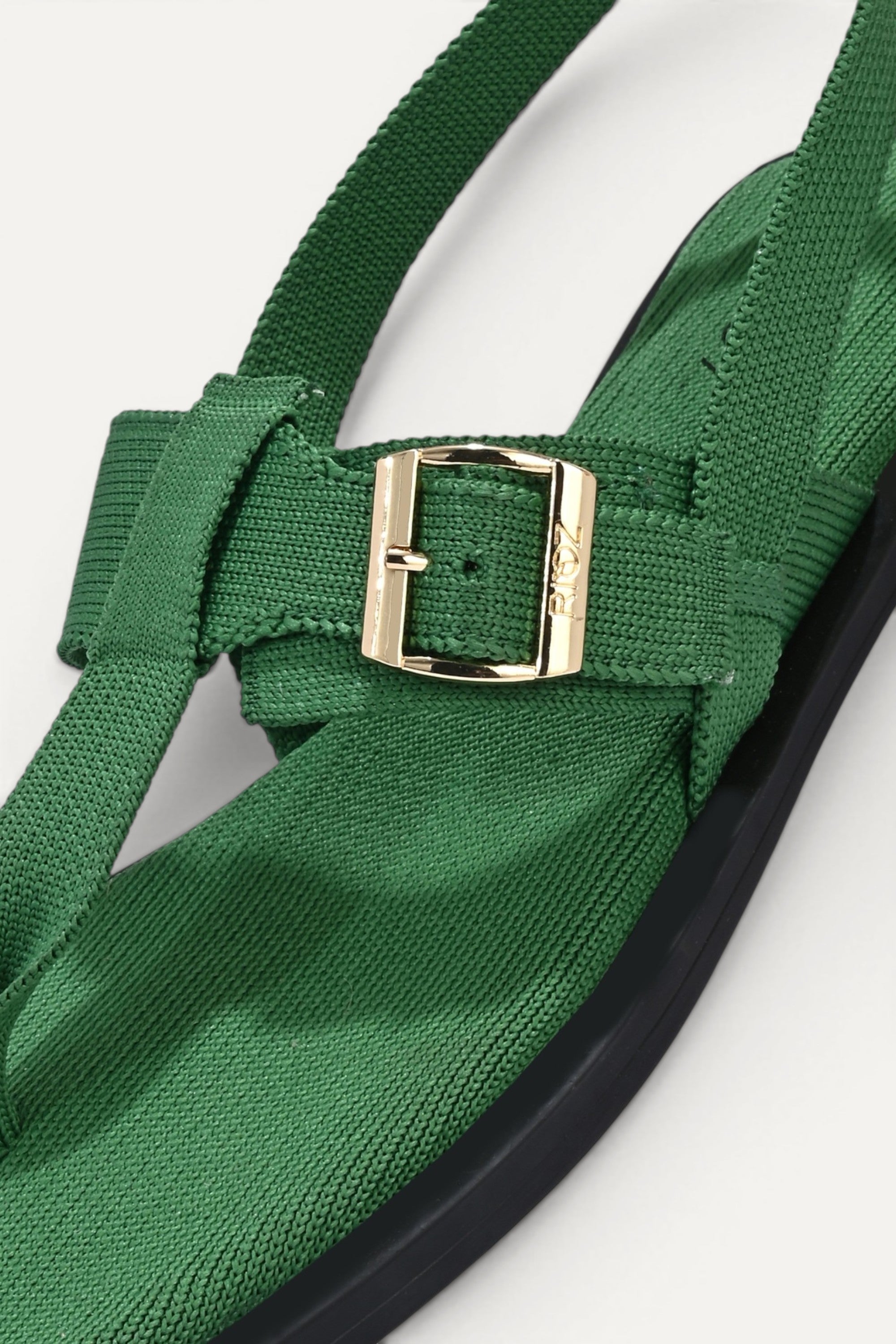 RIOZ eco-friendly green slingback sandals with adjustable buckle straps, breathable woven texture, cushioned footbed, and lightweight sole for comfortable everyday wear.