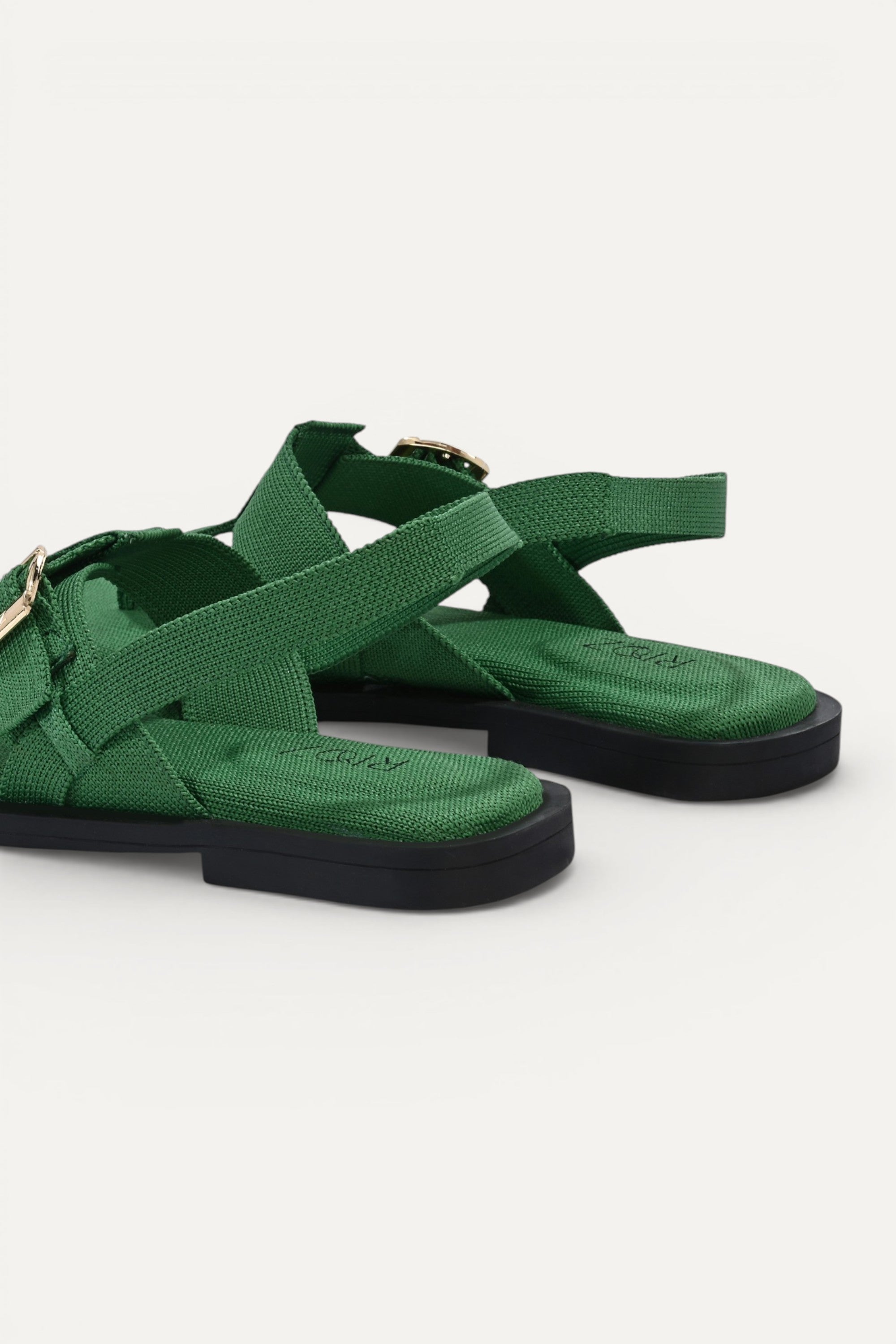 RIOZ eco-friendly green slingback sandals with adjustable buckle straps, breathable woven texture, cushioned footbed, and lightweight sole for comfortable everyday wear.