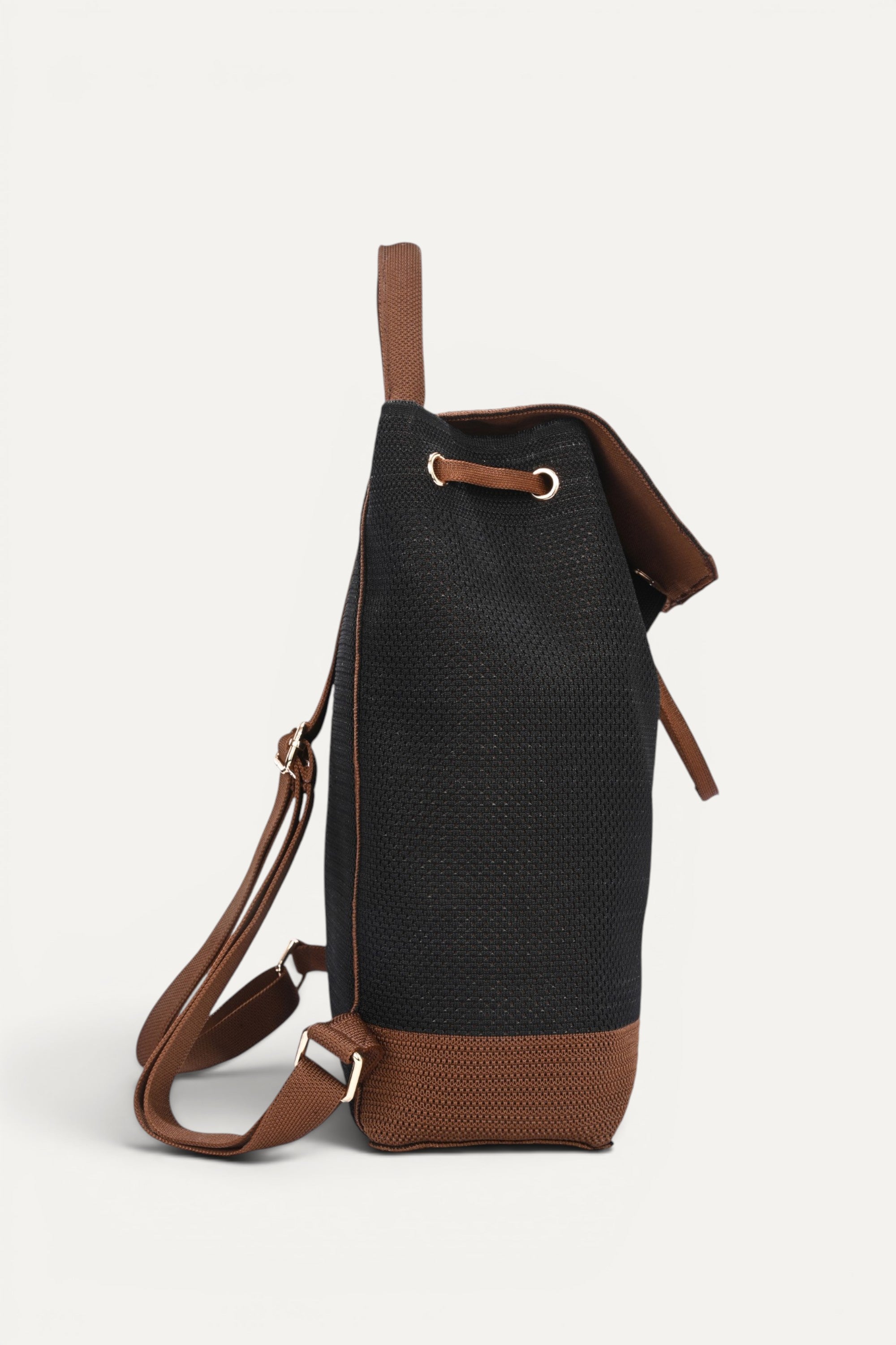 Eco-friendly black woven backpack with brown trim, flap closure and drawstring detail, top handle and shoulder straps, minimalist sustainable design and made from recycled PET bottles for for everyday use.