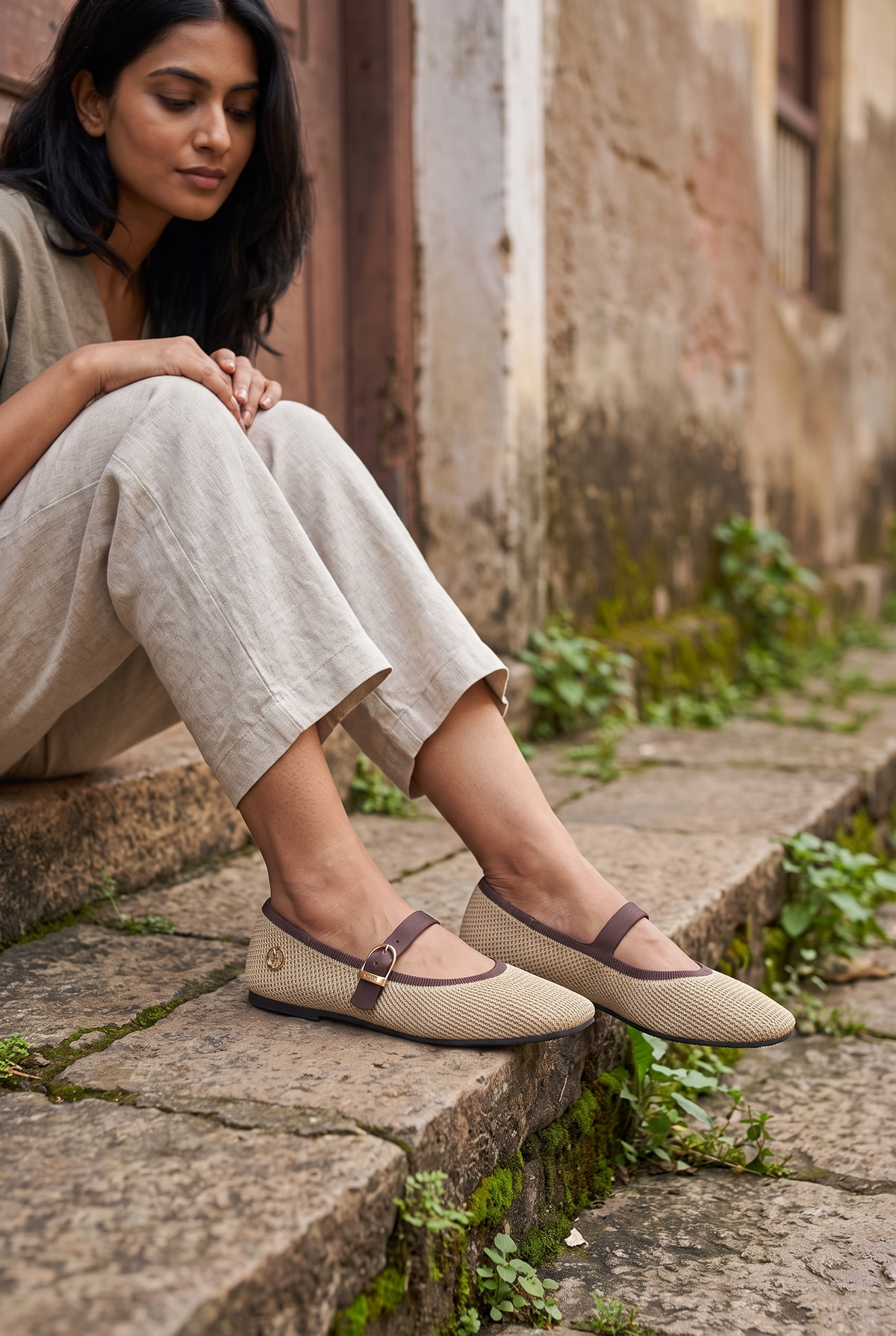 Square Toe Metro Duet Mary Janes Latte full model shot on Indian woman, seated on stone step pose