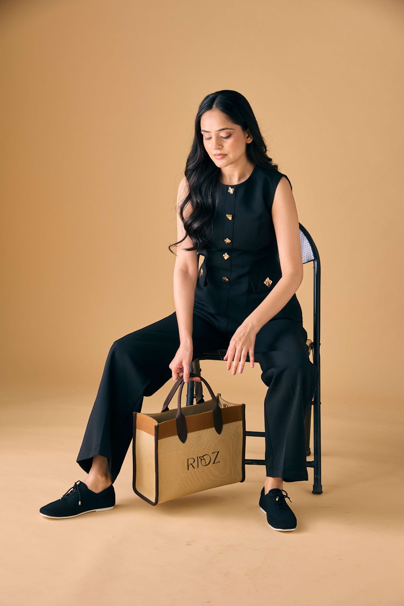 Rioz black knitted lace-up shoes with breathable mesh design, lightweight casual sneakers for women with flexible sole, angled view on neutral background.