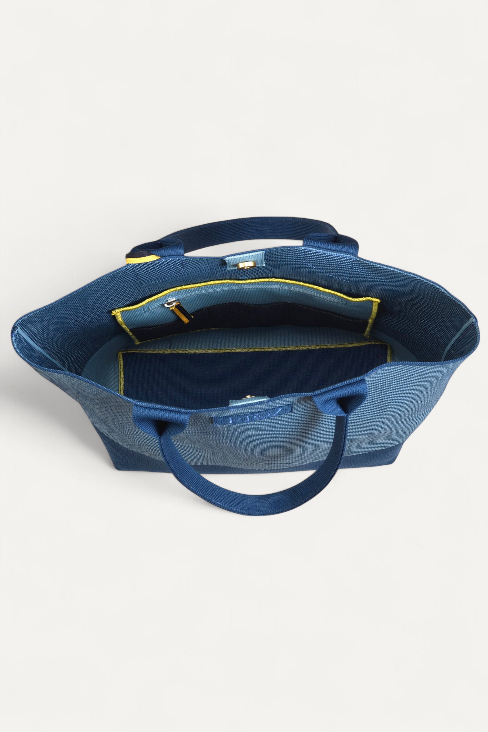 Rioz blue tote bag for women with dual handles, spacious design, and stylish fabric finish  made from recycled PET bottles for sustainable everyday use.