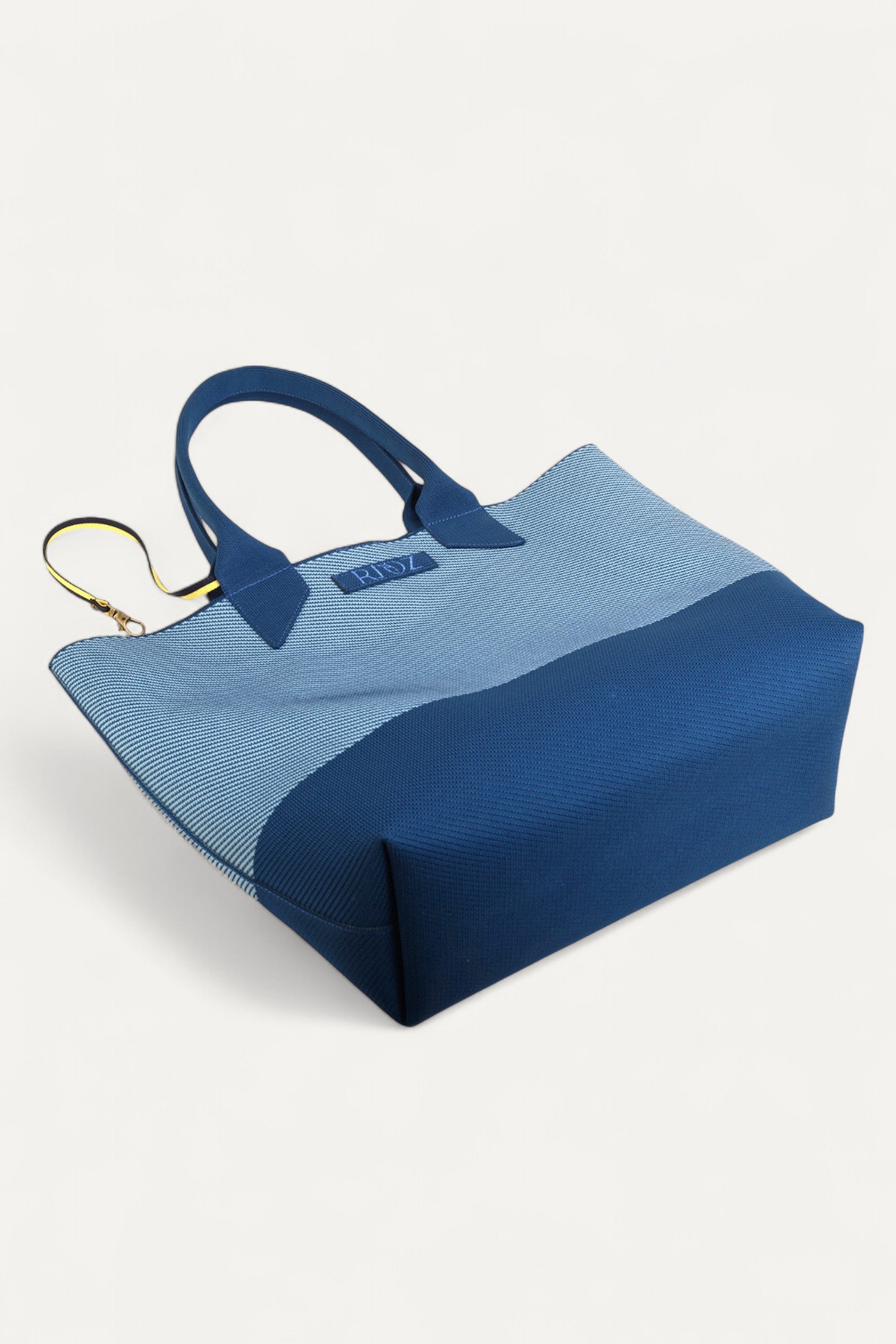 Rioz blue tote bag for women with dual handles, spacious design, and stylish fabric finish  made from recycled PET bottles for sustainable everyday use.