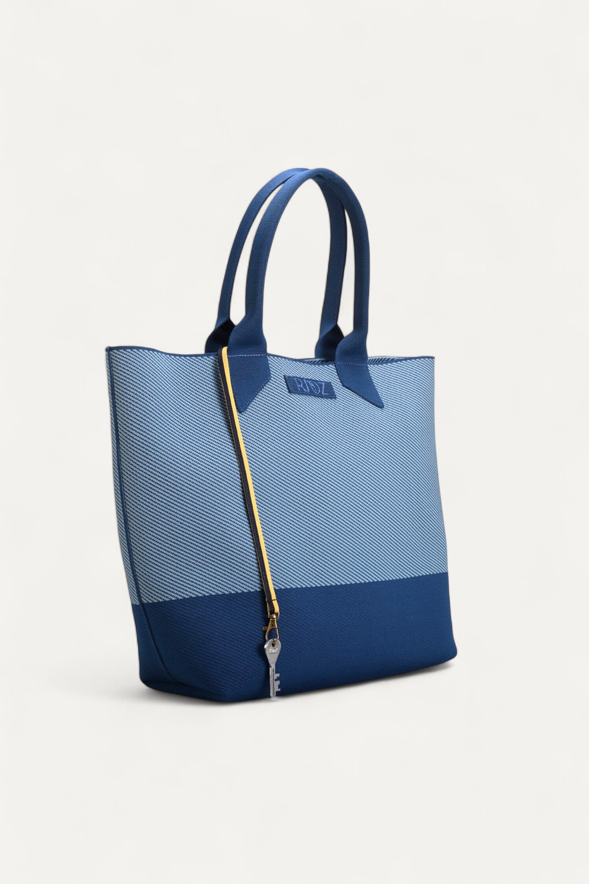 Rioz blue tote bag for women with dual handles, spacious design, and stylish fabric finish  made from recycled PET bottles for sustainable everyday use.