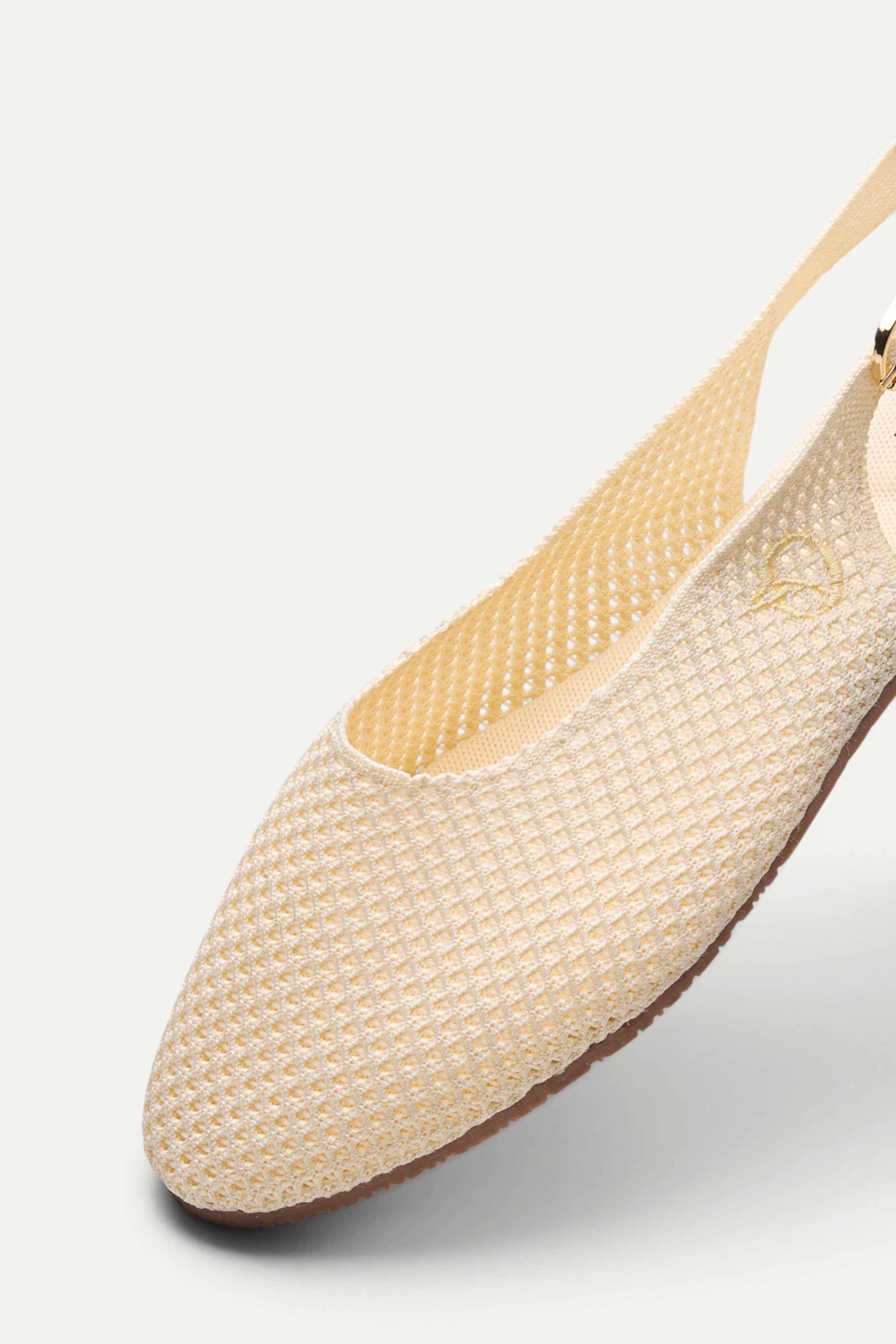 Side view of Rioz Ivory Airknit Slingbacks, breathable open-mesh almond-toe knit flats for women.
