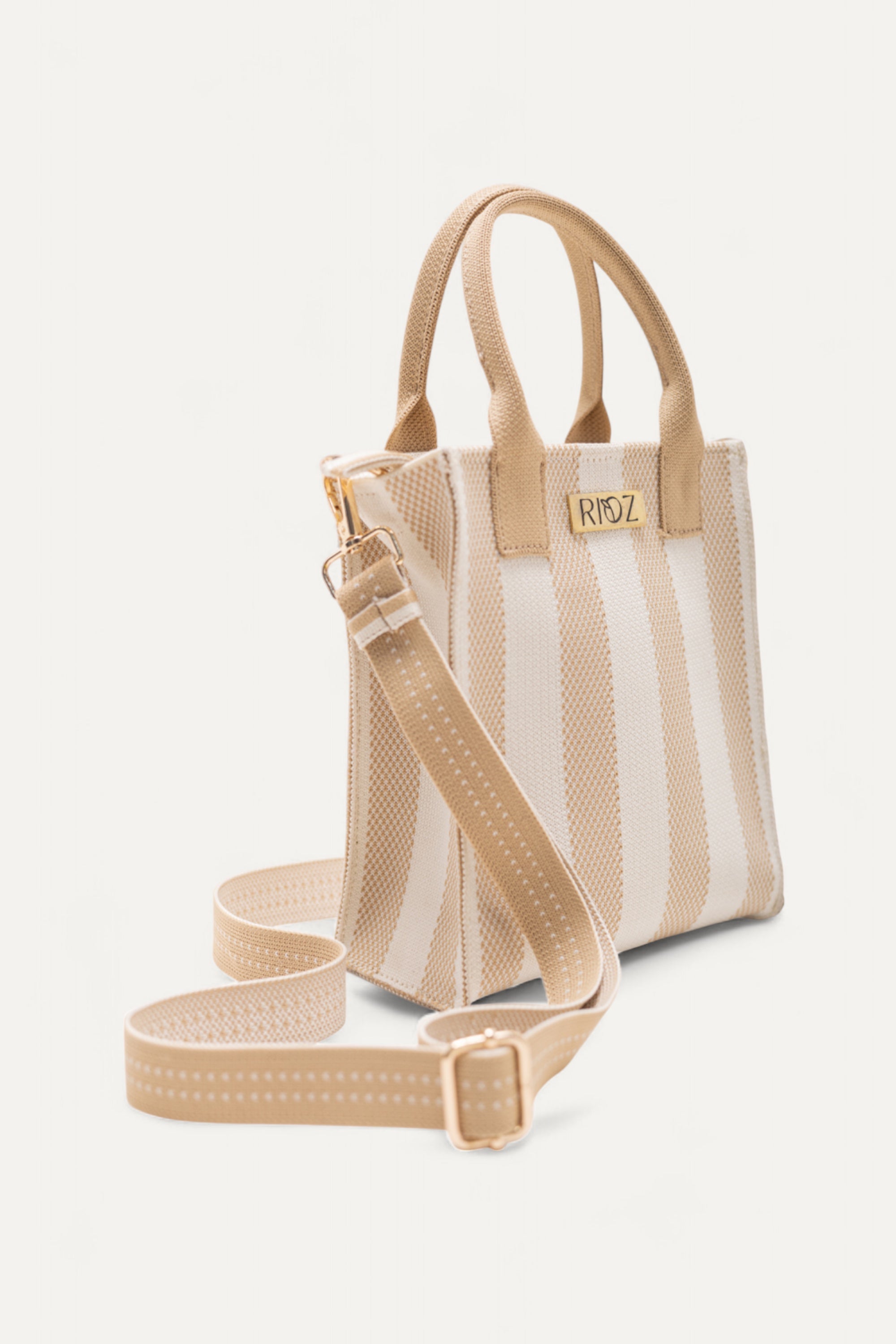 Close-up of Midday Mini tote bag in ivory and wheat stripes by Rioz showing its adjustable strap and compact, eco-friendly design.
