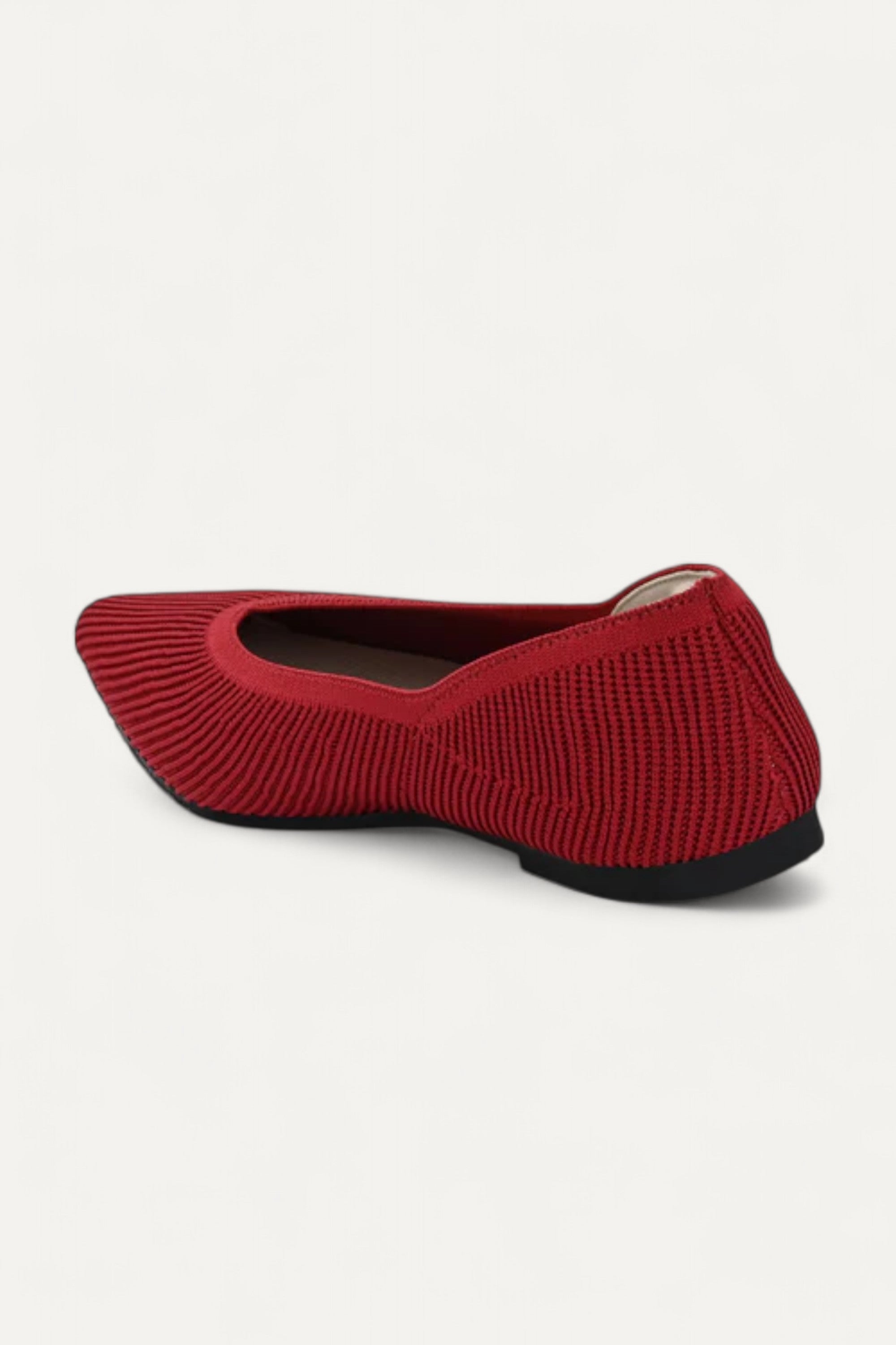 Back view of red pointed-toe ballet flat on white background