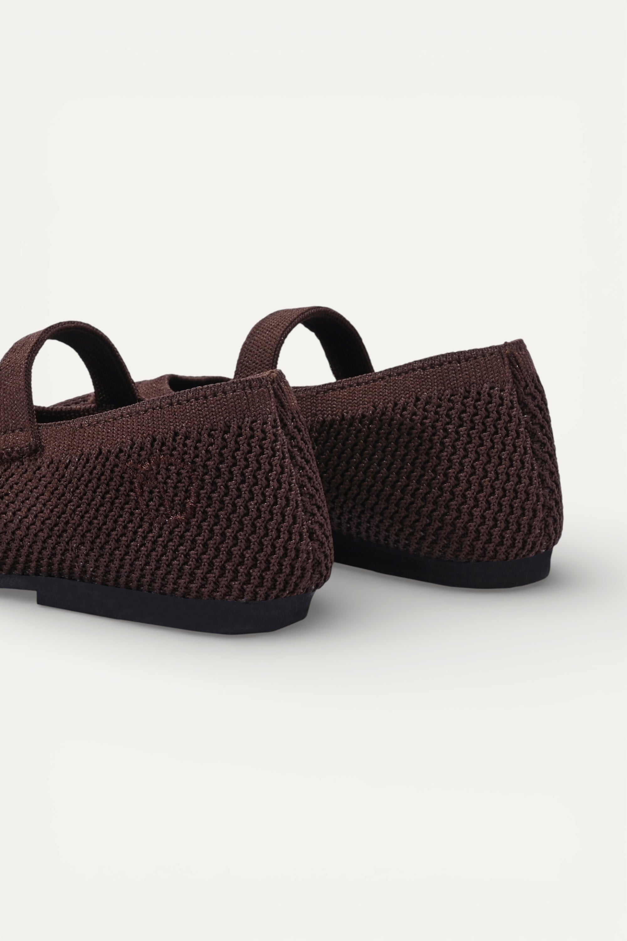 Kids Brown knit Mary Jane shoes with black strap, made using zero-waste 3D knitting from recycled PET (rPET) plastic bottles, lightweight breathable round-toe flats for everyday wear.