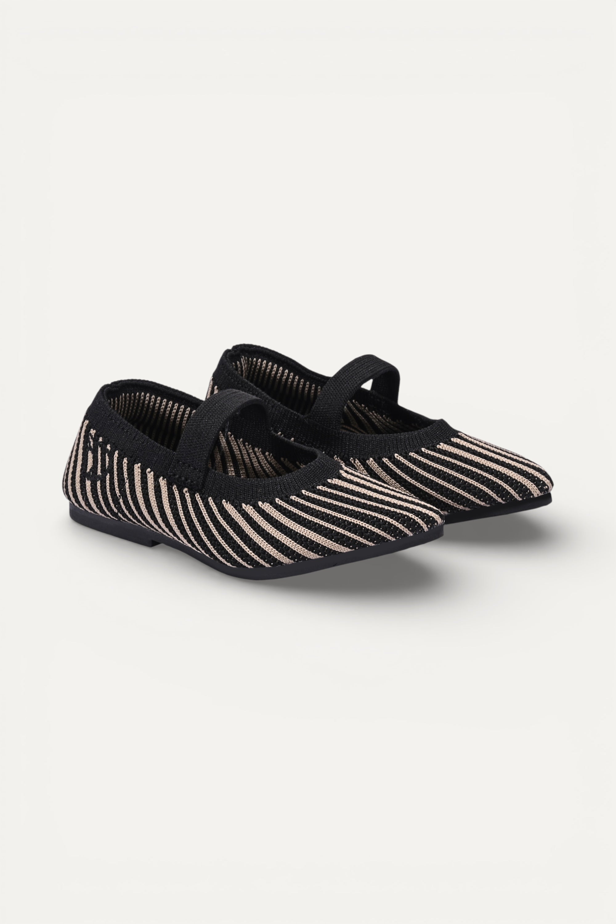 Kids cream knit Mary Jane shoes with black strap, made using zero-waste 3D knitting from recycled PET (rPET) plastic bottles, lightweight breathable round-toe flats for everyday wear.