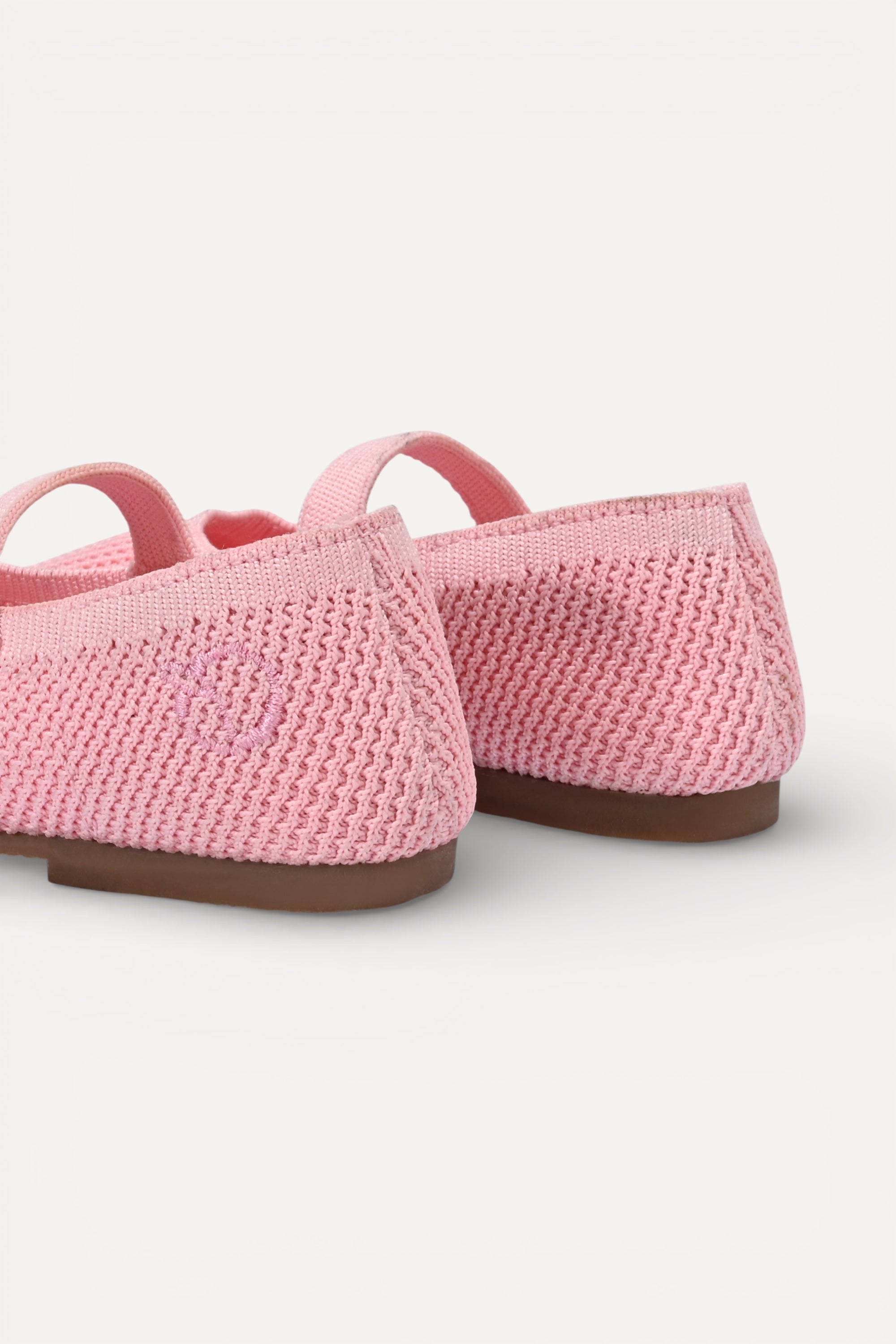 Kids Baby Pink knit Mary Jane shoes with black strap, made using zero-waste 3D knitting from recycled PET (rPET) plastic bottles, lightweight breathable round-toe flats for everyday wear.