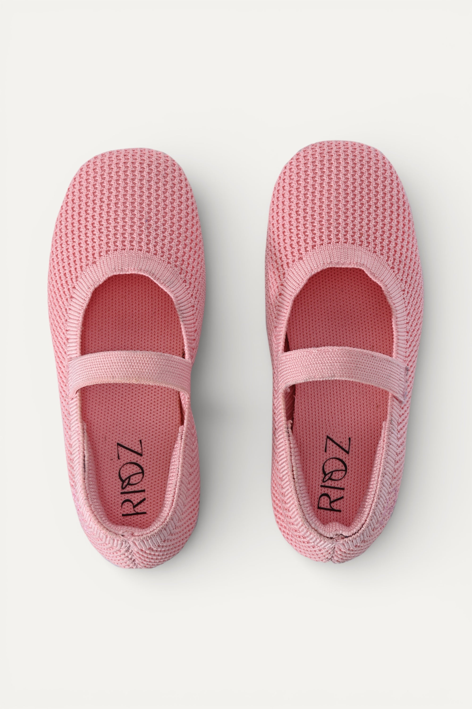 Kids Baby Pink knit Mary Jane shoes with black strap, made using zero-waste 3D knitting from recycled PET (rPET) plastic bottles, lightweight breathable round-toe flats for everyday wear.