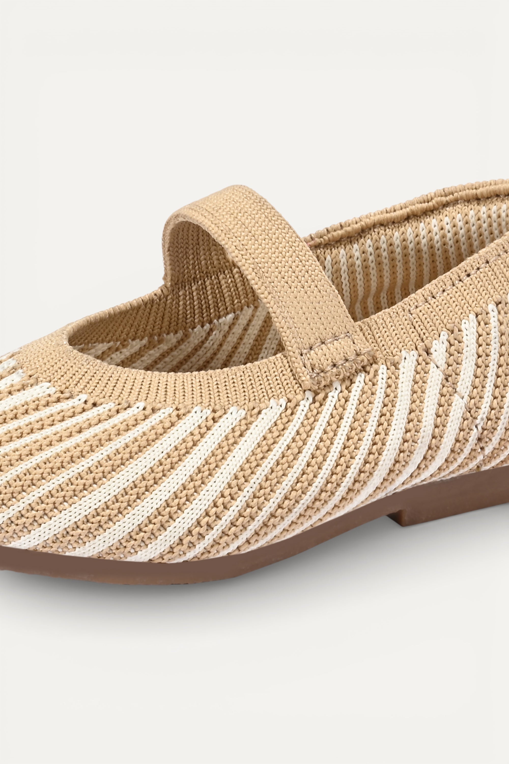 Beige and cream knit Mary Jane flats with strap, breathable striped pattern upper, lightweight flexible sole, comfortable everyday footwear for kids.