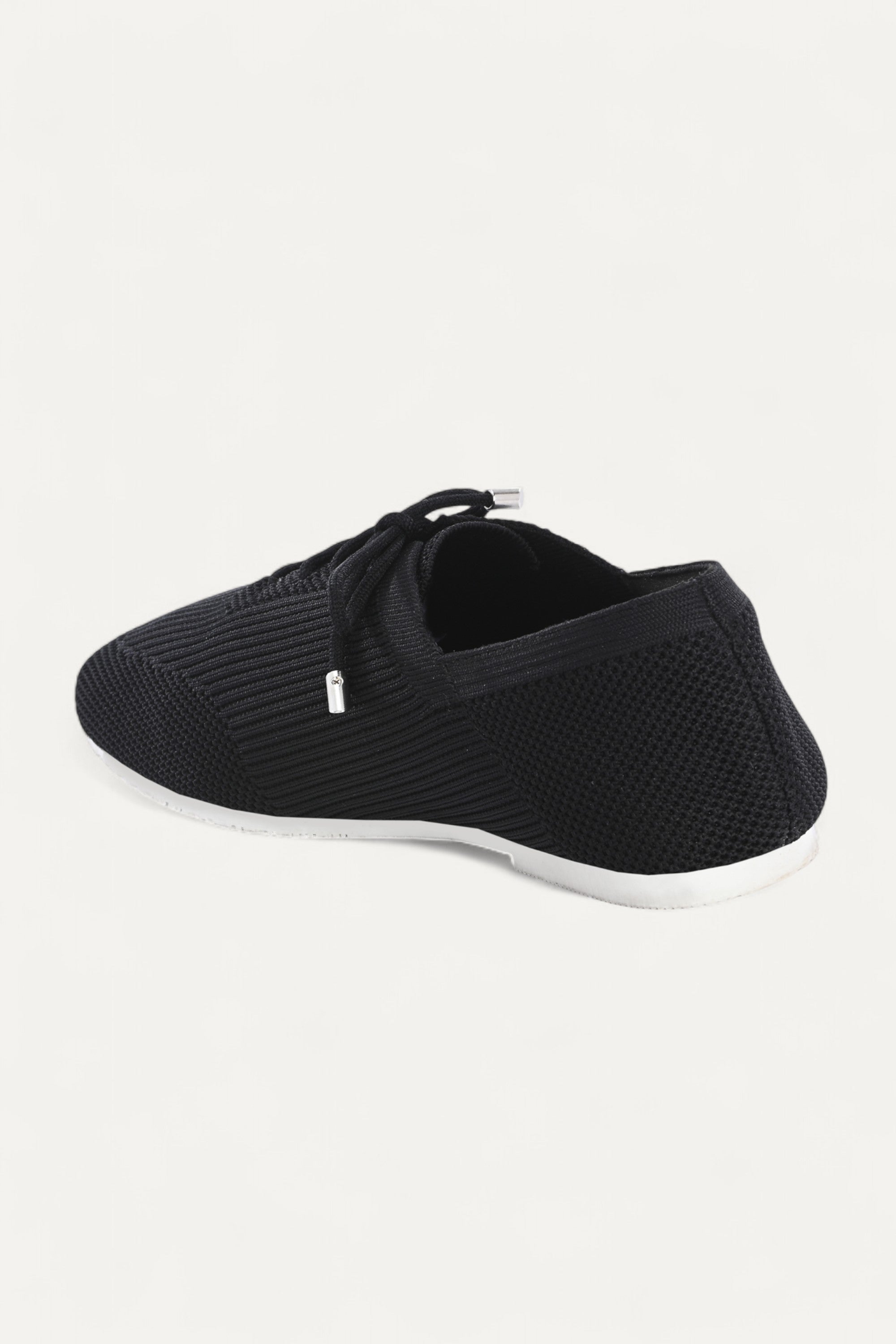 Rioz black knitted lace-up shoes with breathable mesh design, lightweight casual sneakers for women with flexible sole, angled view on neutral background.