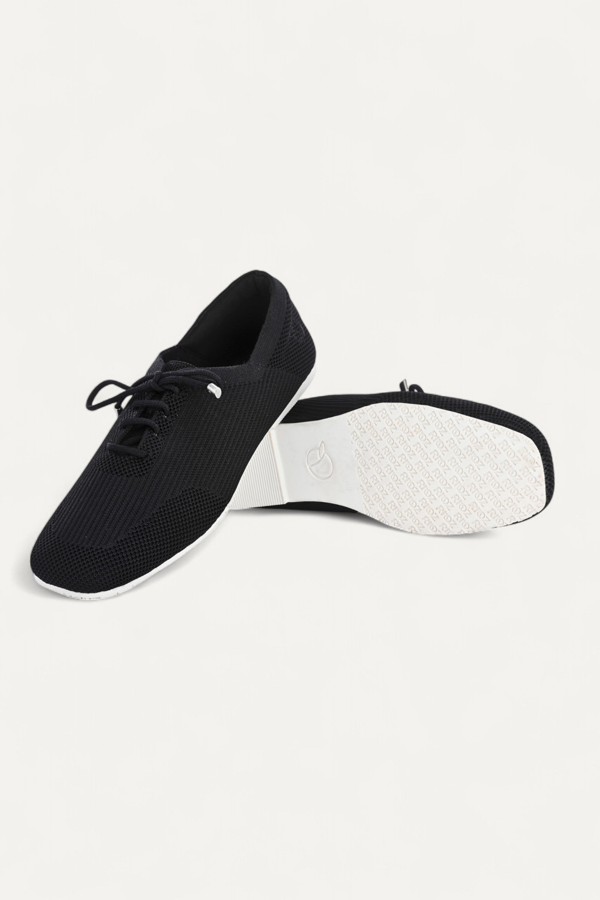 Rioz black knitted lace-up shoes with breathable mesh design, lightweight casual sneakers for women with flexible sole, angled view on neutral background.