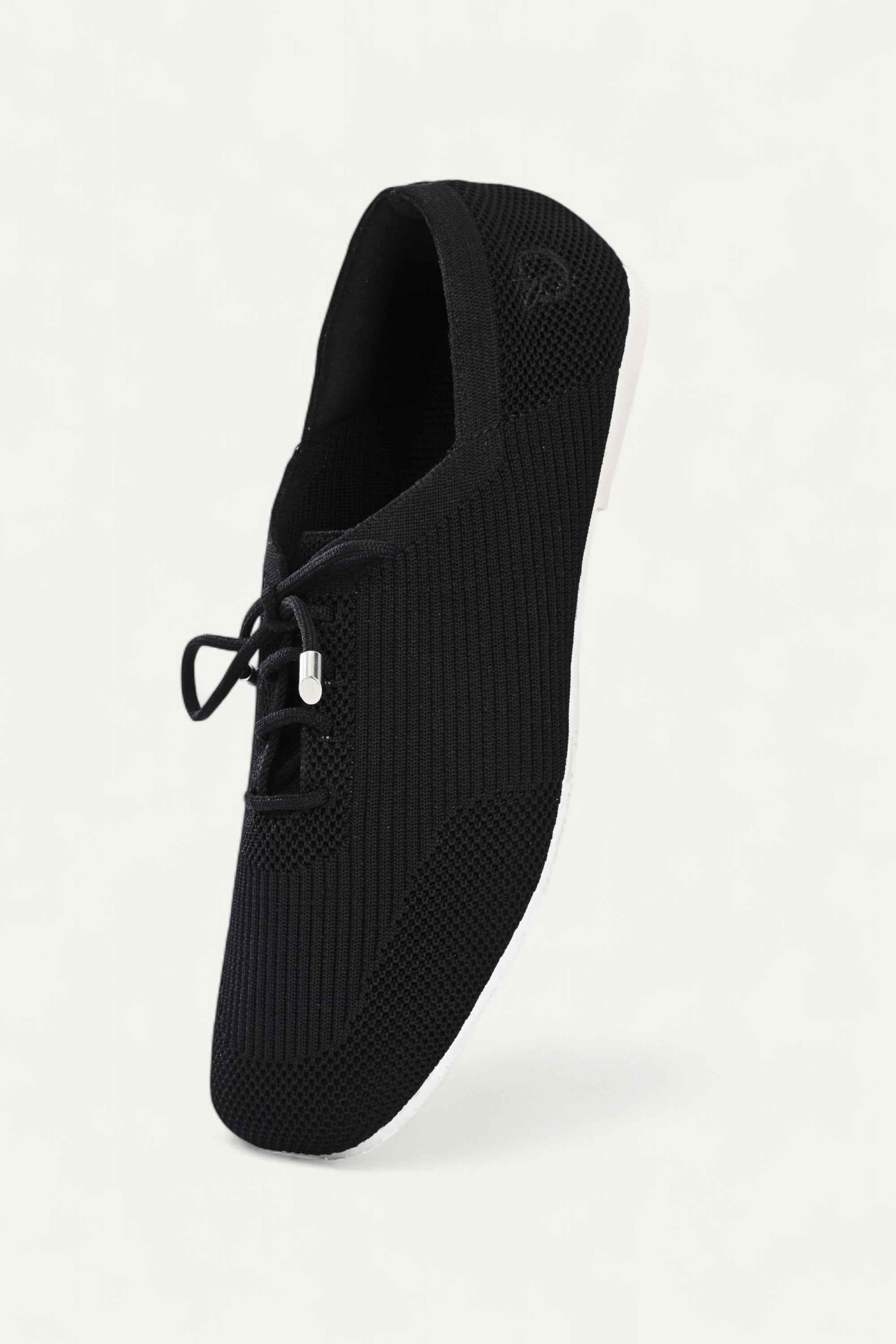 Rioz black knitted lace-up shoes with breathable mesh design, lightweight casual sneakers for women with flexible sole, angled view on neutral background.
