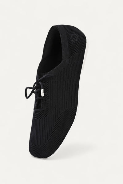 Rioz black knitted lace-up shoes with breathable mesh design, lightweight casual sneakers for women with flexible sole, angled view on neutral background.
