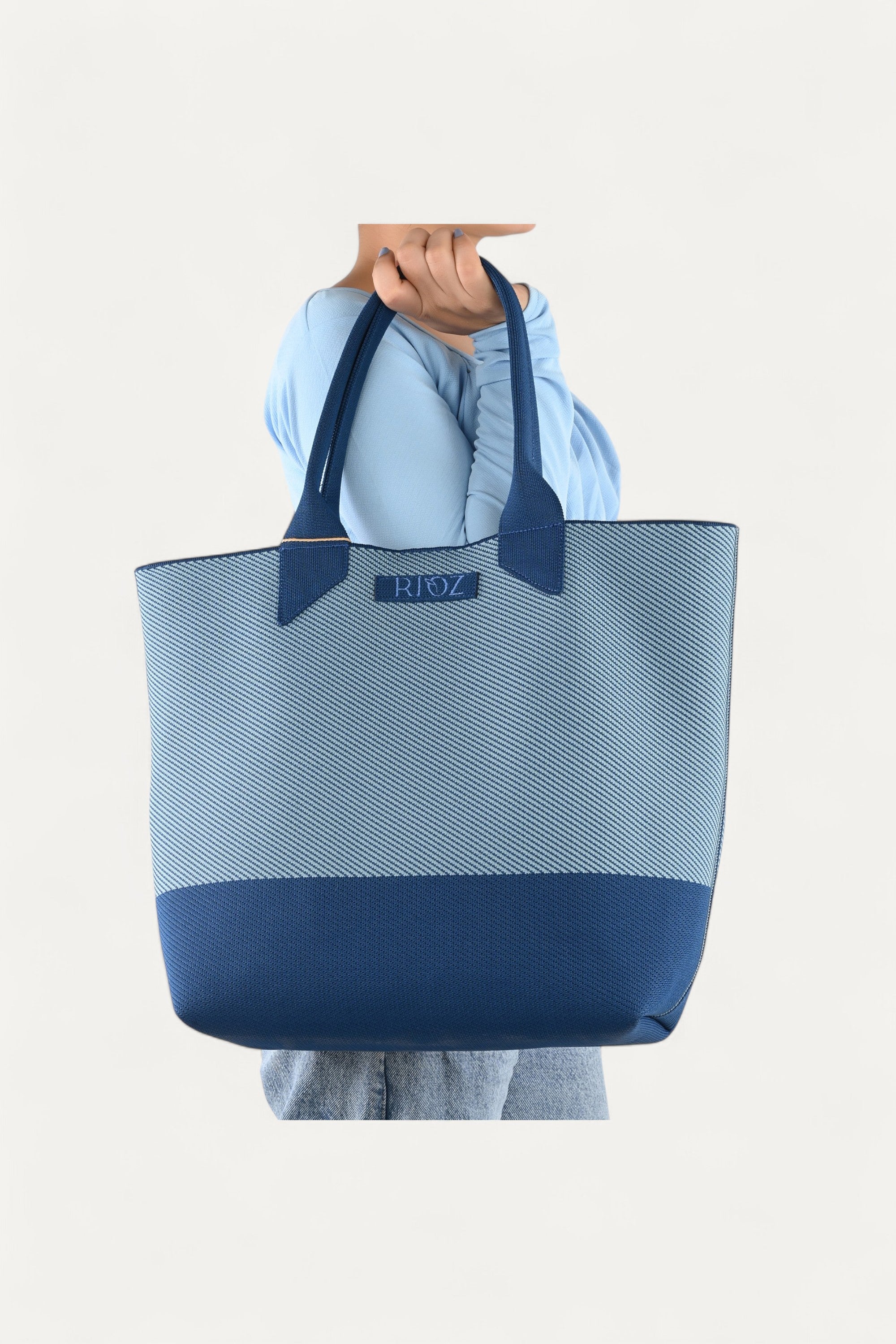 Rioz blue tote bag for women with dual handles, spacious design, and stylish fabric finish  made from recycled PET bottles for sustainable everyday use.