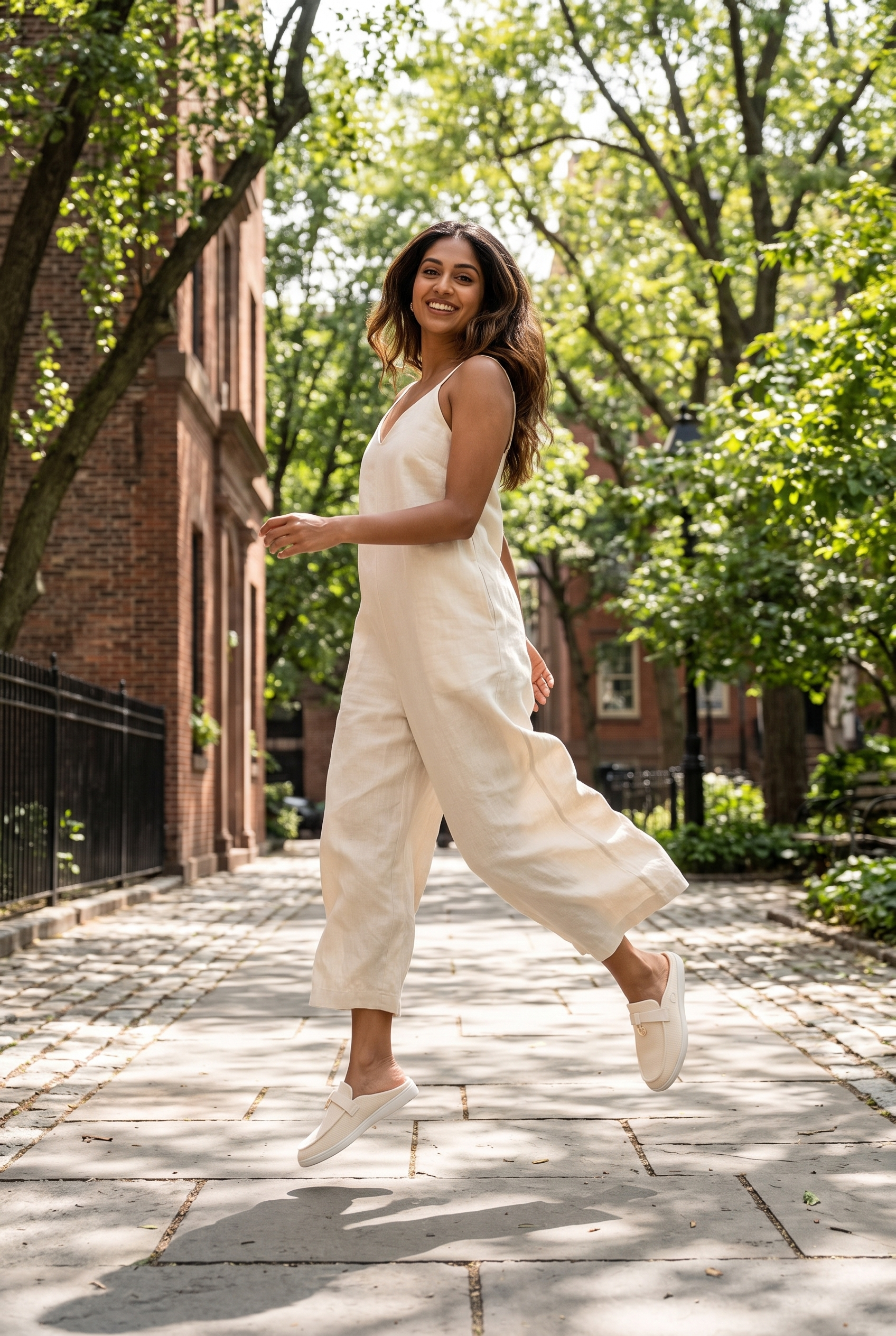 Coco Mules Ivory full model shot on Indian woman, playful hop pose