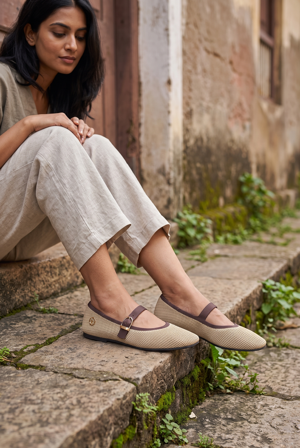 Square Toe Metro Duet Mary Janes Latte full model shot on Indian woman, seated on stone step pose
