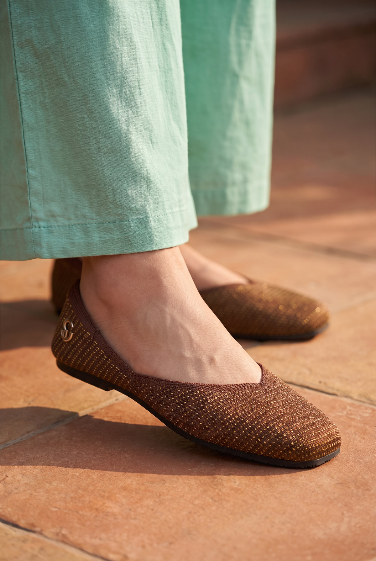 Sitara Juttis Brown Gold foot closeup on Indian woman in traditional palazzo