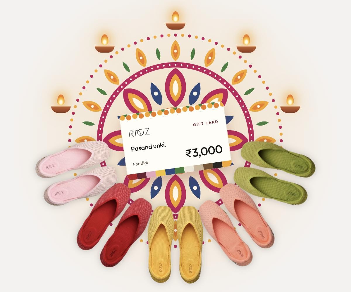 A Rioz gift card at the centre of a rangoli, with five pairs of the new shimmer juttis around it